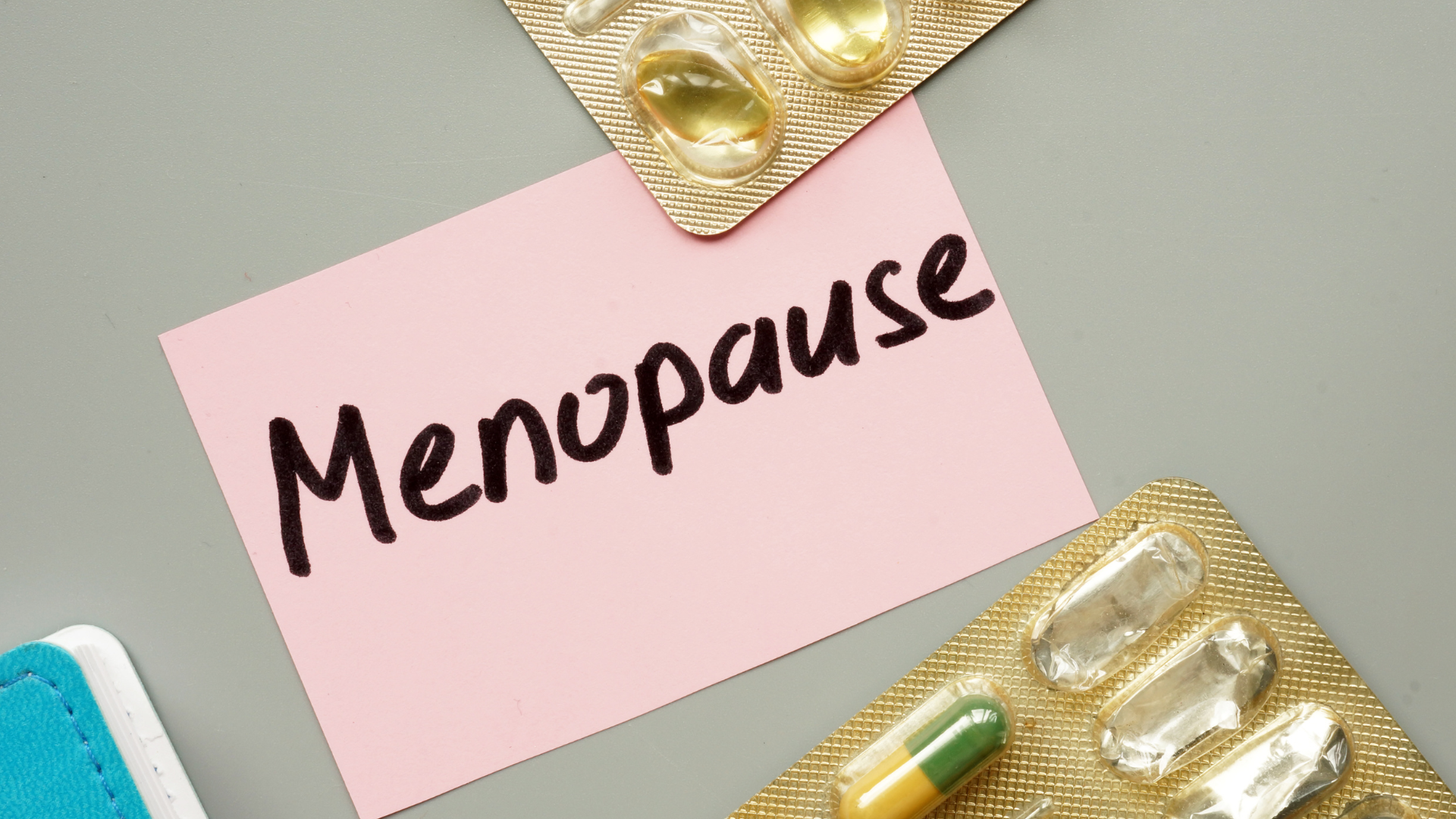Image with text saying Menopause with some pill packs around the text.